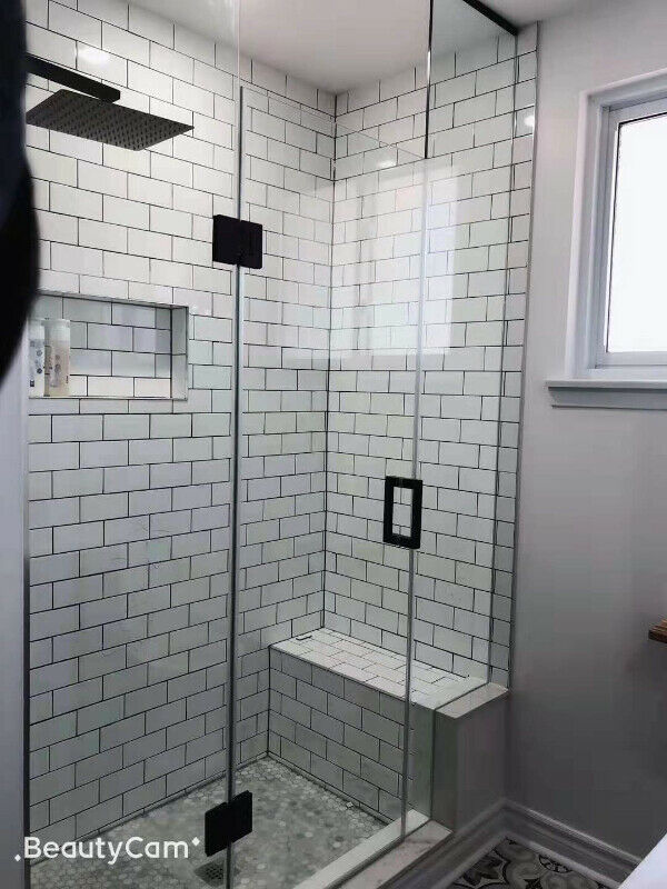 Bathroom renovation with white subway tile and glass shower